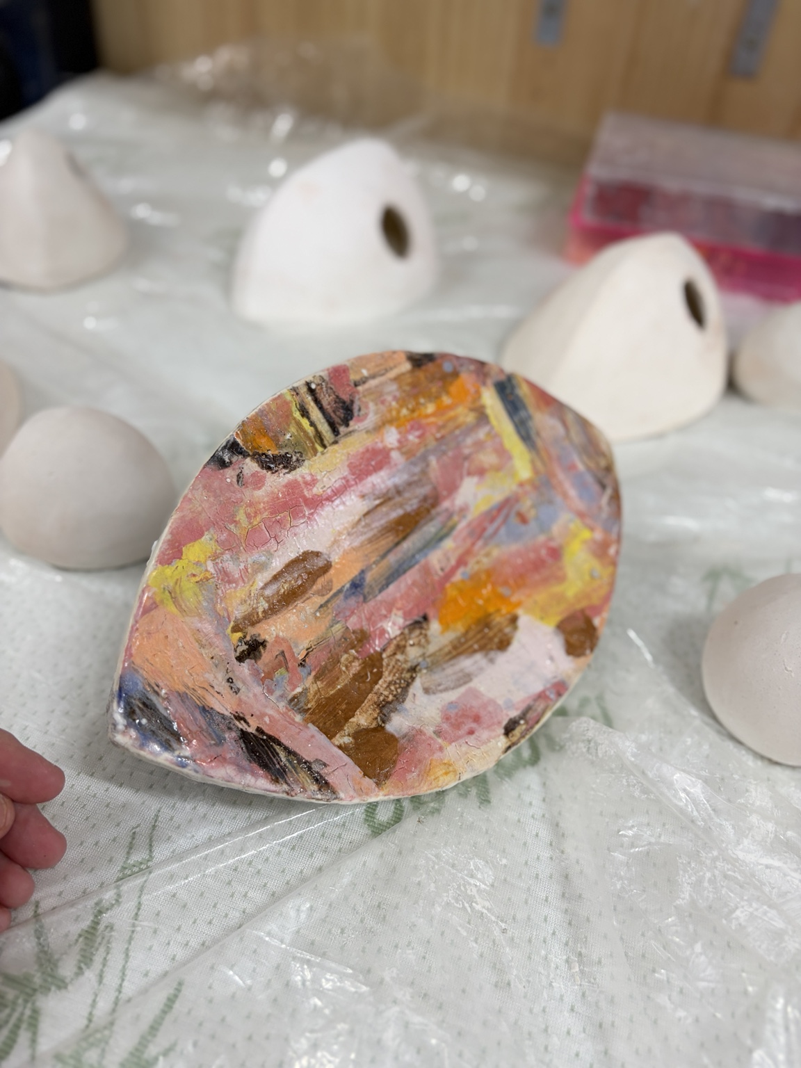 The brightly coloured ceramic pod with its monoprinted front beneath clear crackle glaze
